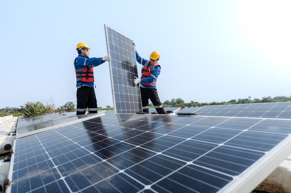 male,workers,repair,floating,solar,panels,on,water,lake.,engineers